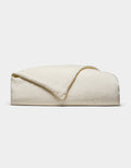 The Cozy Earth Linen Duvet Cover, in an off-white shade, is neatly folded against a white background. Its soft, slightly textured fabric is visible with one corner casually turned over.|Color:Flax