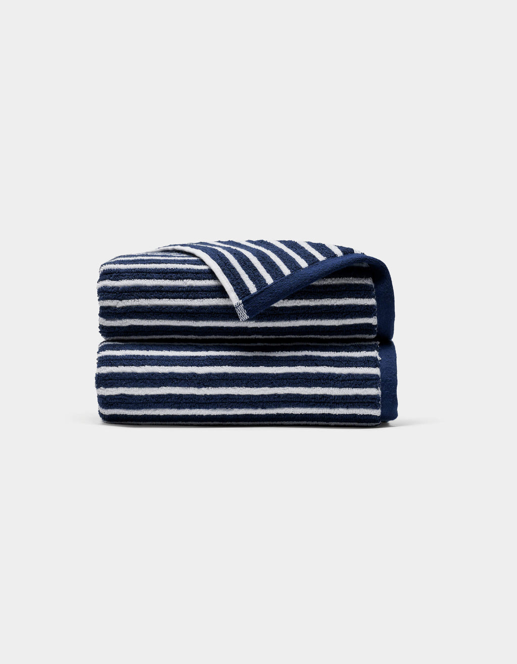 A Ribbed Terry Hand Towel by Cozy Earth, featuring horizontal navy blue and white stripes, is neatly folded against a plain light gray background.|Color:Obsidian Stripe