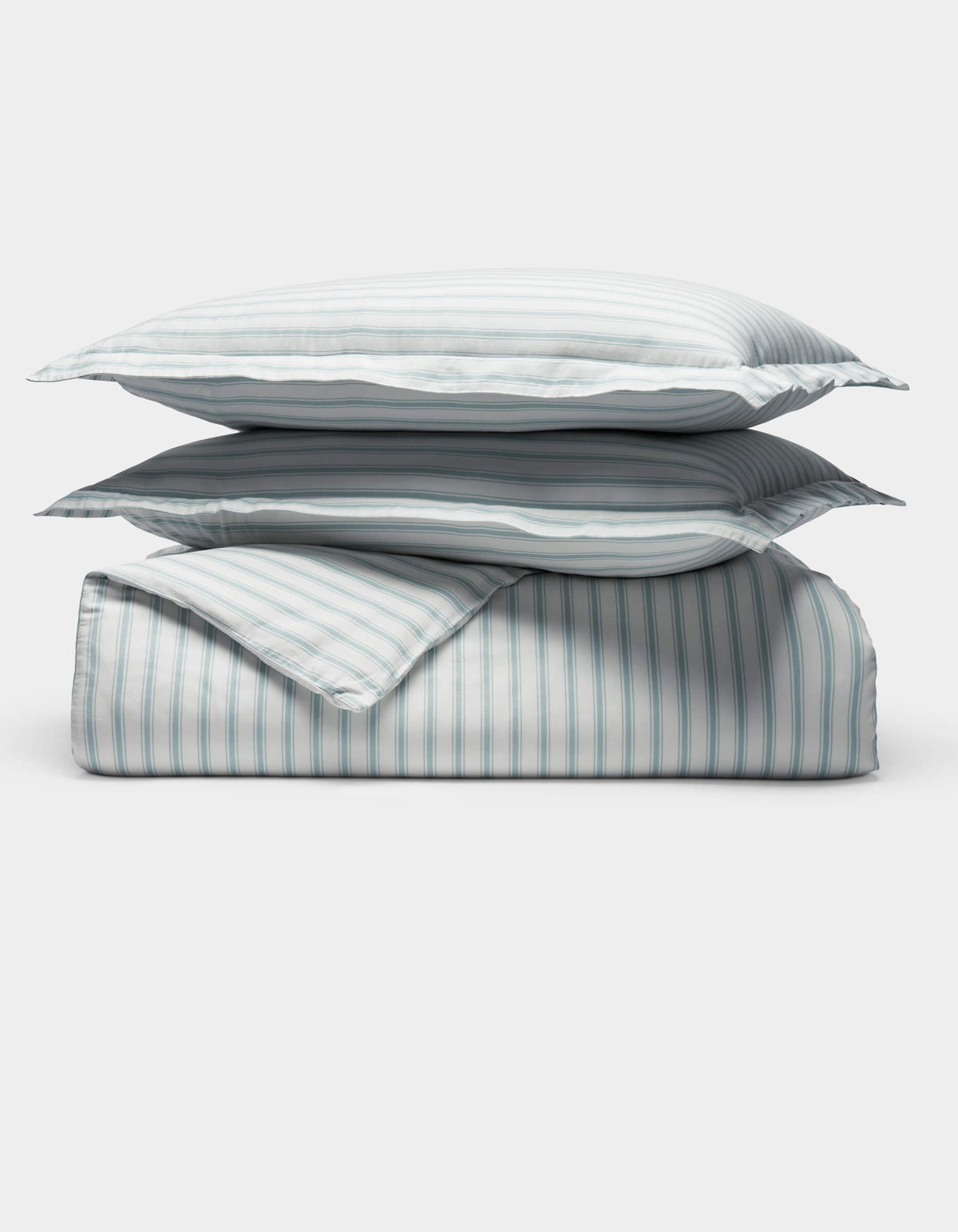 The Cozy Earth Soft-Wash Cotton Duvet Set is displayed neatly folded with two stacked pillows and a comforter, all in a light blue and white vertical striped pattern, set against a plain white background.|Color:River and Sea Salt Stripe