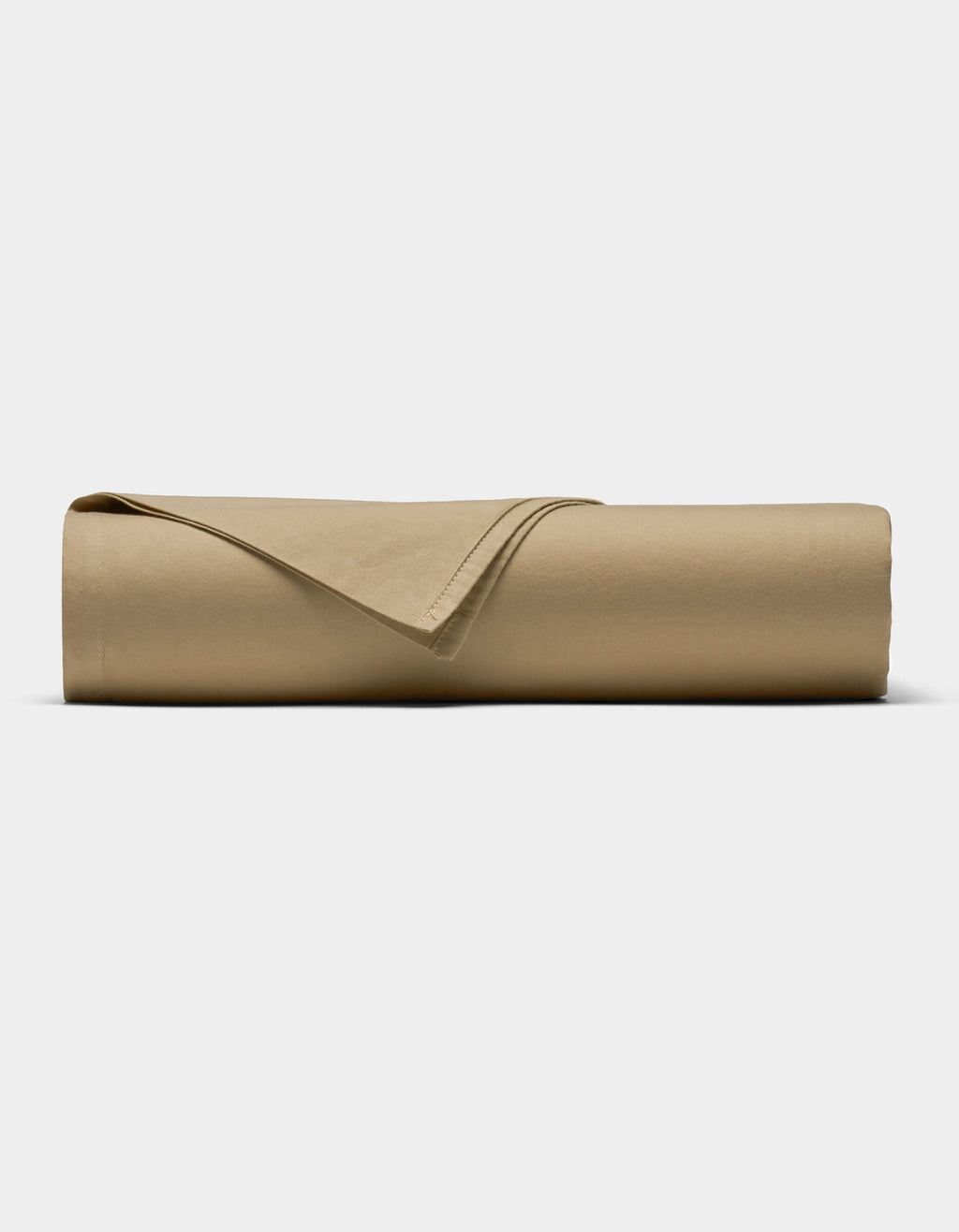 The Soft-Wash Cotton Sheet Set by Cozy Earth in tan is neatly rolled into a cylinder, with one corner folded back, displayed against a plain white background.|Color:Sandalwood