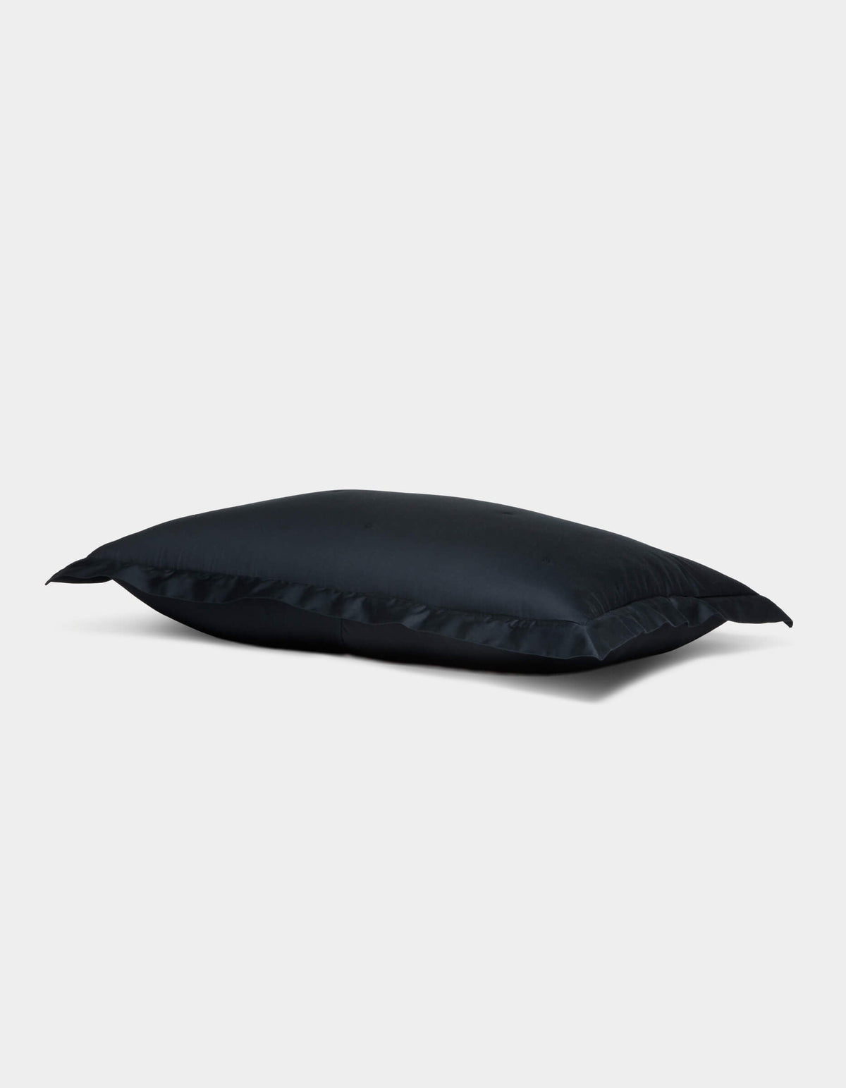 The Soft-Wash Cotton Quilted Sham by Cozy Earth is displayed on a plain light gray background. The rectangular sham appears slightly puffed, featuring neat edges, a smooth surface, and a subtle sheen. |Color:Eclipse