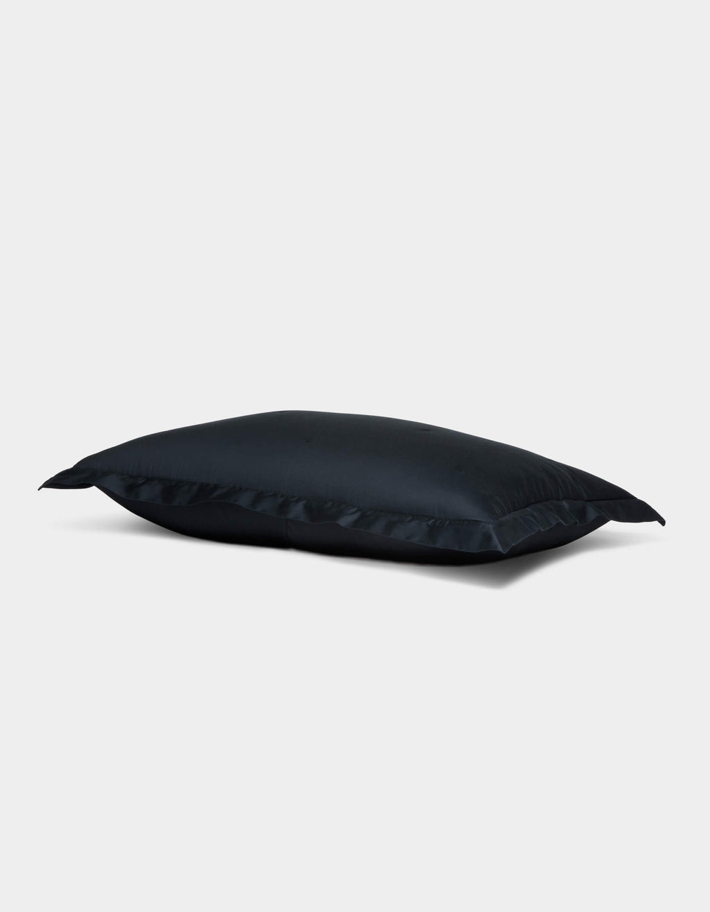 The Soft-Wash Cotton Quilted Sham by Cozy Earth is displayed on a plain light gray background. The rectangular sham appears slightly puffed, featuring neat edges, a smooth surface, and a subtle sheen. |Color:Eclipse