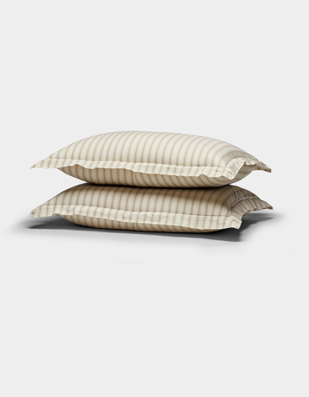 Two Soft-Wash Cotton Quilted Shams by Cozy Earth, in beige and white stripes, are stacked against a plain white background.|Color:Coconut and Sandalwood Stripe