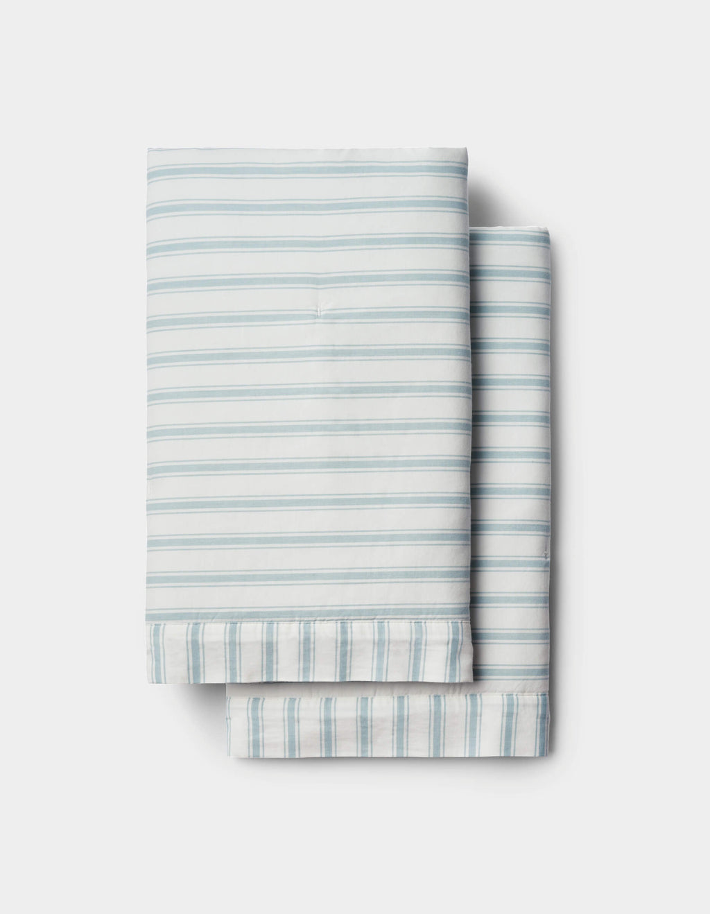 Soft-Wash Cotton Quilted Shams by Cozy Earth in light blue and white stripes are neatly folded and stacked on a white background.|Color:River and Sea Salt Stripe