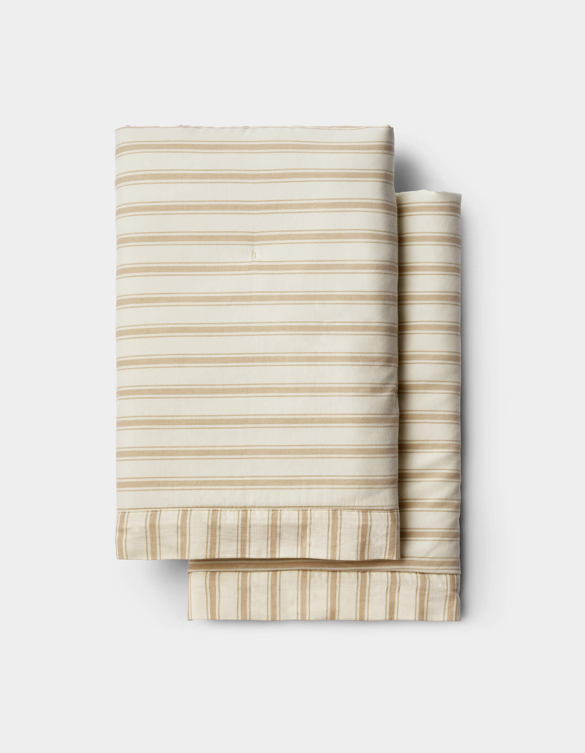 Cozy Earth’s Soft-Wash Cotton Duvet Set in beige and white stripes is neatly folded and stacked on a white background.|Color:Coconut and Sandalwood Stripe
