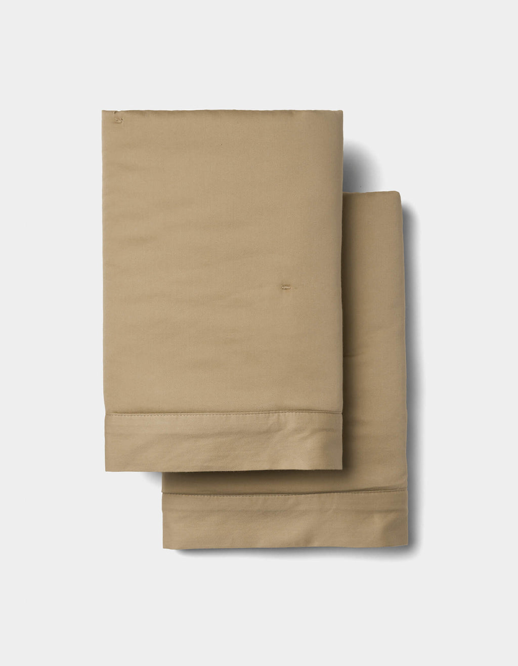 Two Soft-Wash Cotton Quilted Shams by Cozy Earth, neatly folded and stacked against a plain white background.|Color:Sandalwood