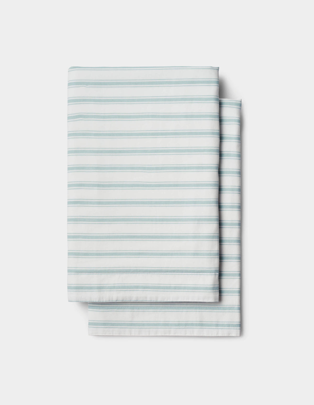 The Soft-Wash Cotton Sheet Set by Cozy Earth features a neatly folded white sheet with light blue horizontal stripes, displayed on a plain white background.|Color:River and Sea Salt Stripe