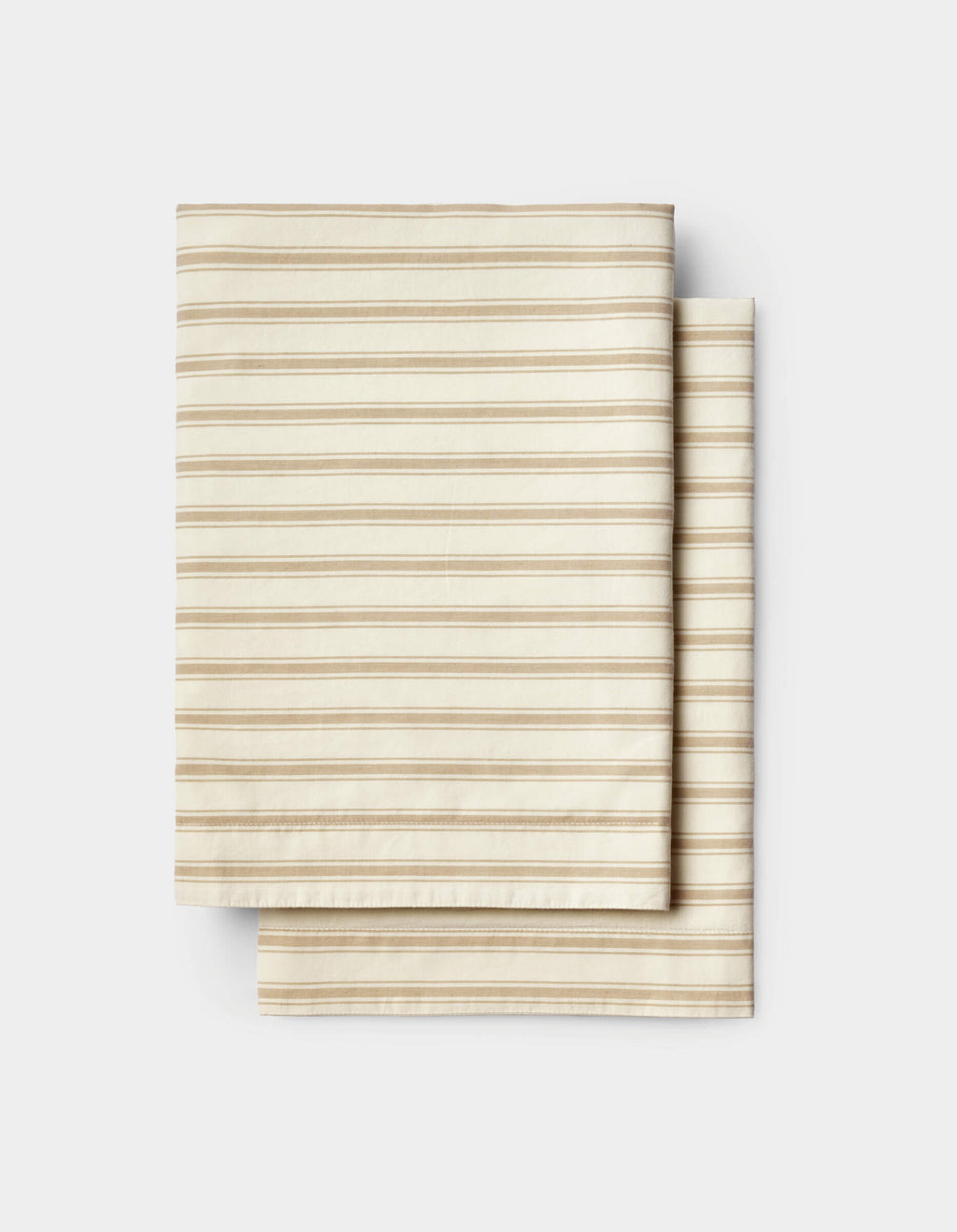 Neatly stacked on a white background, the Cozy Earth Soft-Wash Cotton Sheet Set features folded beige fabric with thin, evenly spaced horizontal brown stripes.|Color:Coconut and Sandalwood Stripe