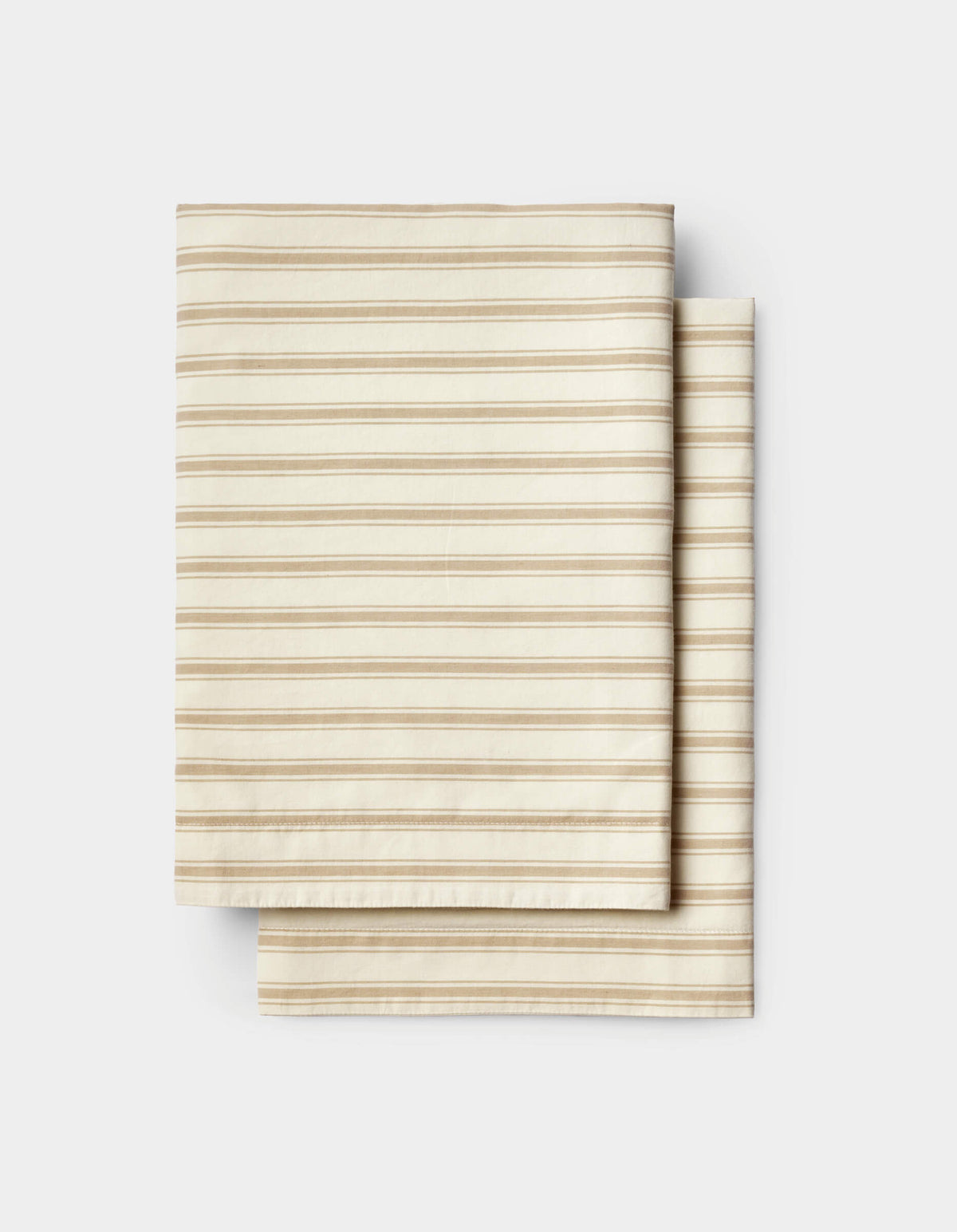 Neatly stacked on a white background, the Cozy Earth Soft-Wash Cotton Sheet Set features folded beige fabric with thin, evenly spaced horizontal brown stripes.|Color:Coconut and Sandalwood Stripe
