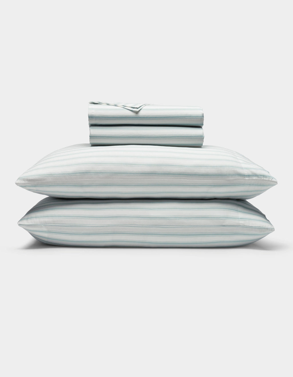 A neatly folded Soft-Wash Cotton Sheet Set by Cozy Earth in light blue and white stripes, featuring two stacked pillows and a folded fitted sheet, displayed on a plain white background.|Color:River and Sea Salt Stripe
