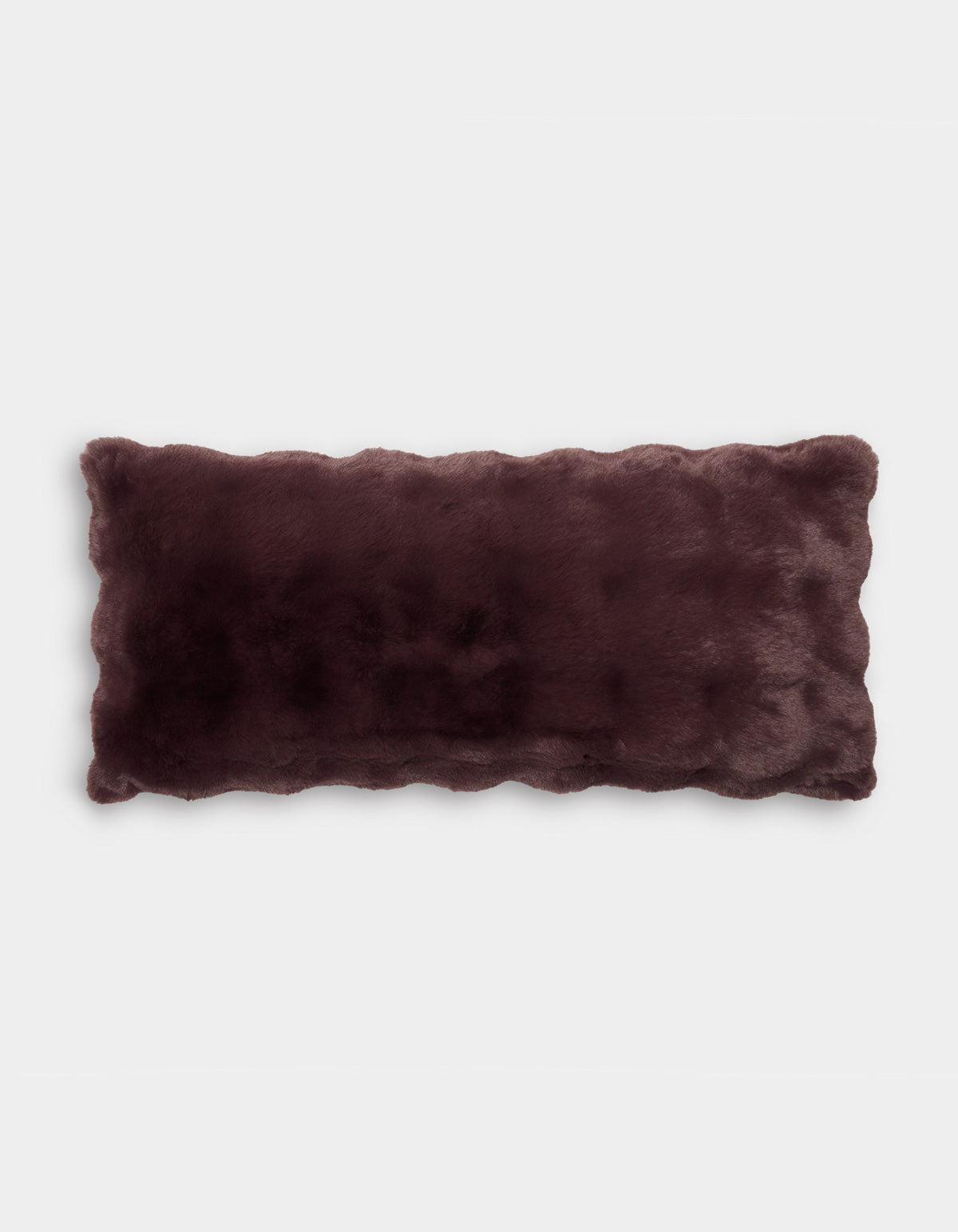 The Bubble Cuddle Pillow by Cozy Earth is a rectangular faux fur pillow in dark brown, featuring scalloped edges and displayed on a plain white background.|Color:Raisin |Size:14" x 30"
