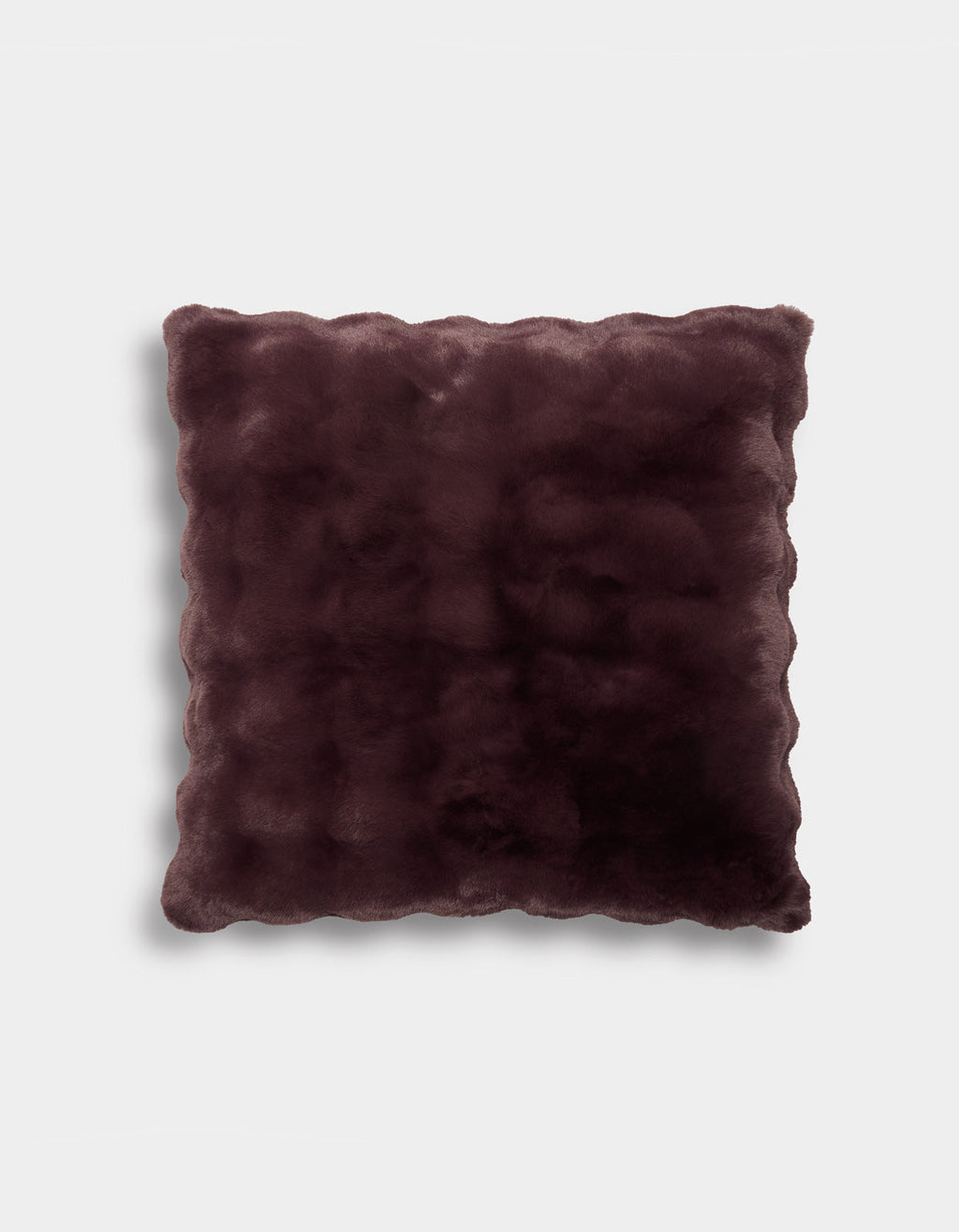The Bubble Cuddle Pillow by Cozy Earth is a square, plush pillow featuring a rich dark burgundy color and elegant scalloped edges. Its soft, velvety surface rests against a plain light gray background.|Color:Raisin |Size:26" x 26"