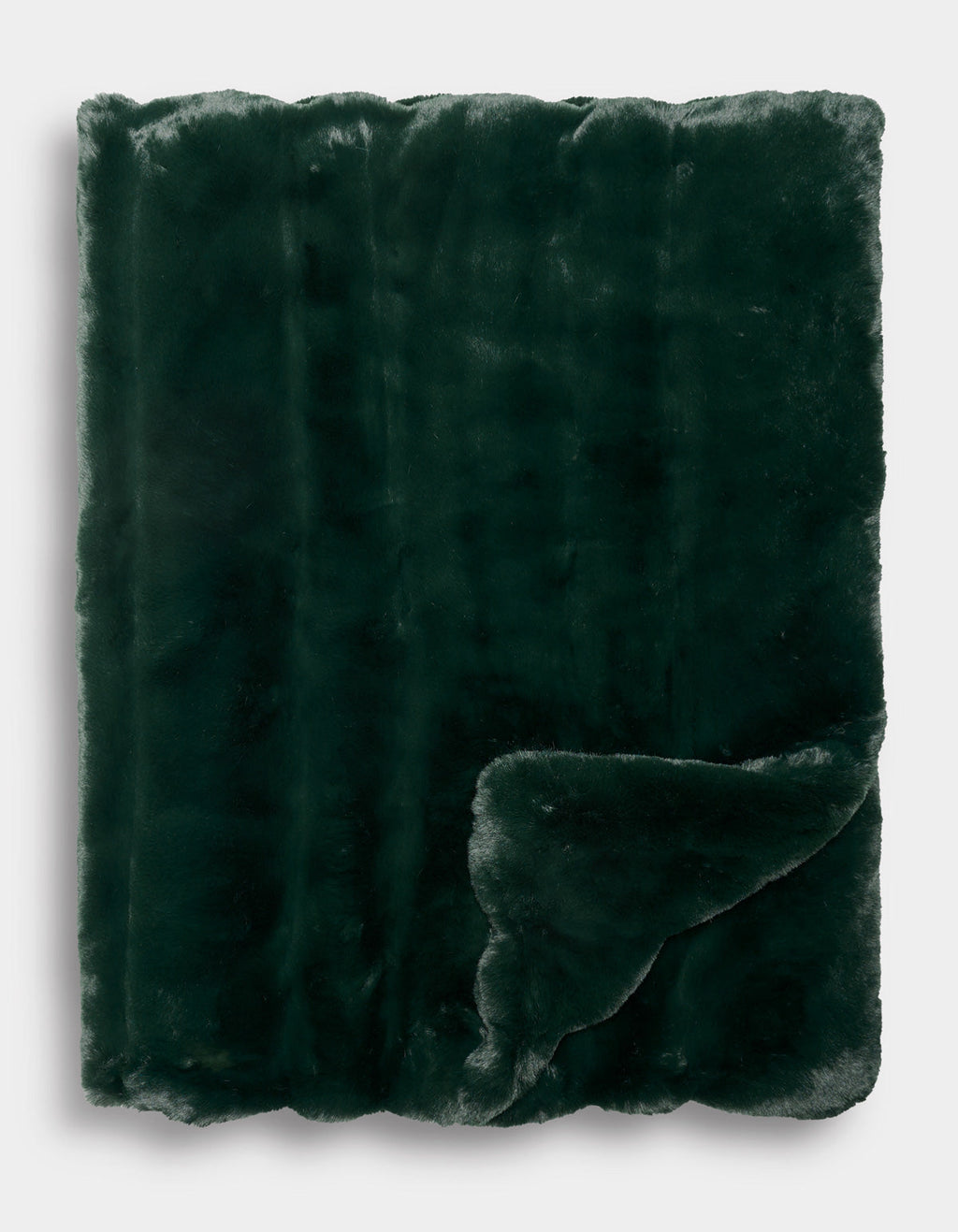 The Cozy Earth Channel Cuddle Blanket is neatly folded, with one corner turned up to reveal its plush texture on both sides. The dark green faux fur looks exceptionally soft and cozy.|Color:Emerald