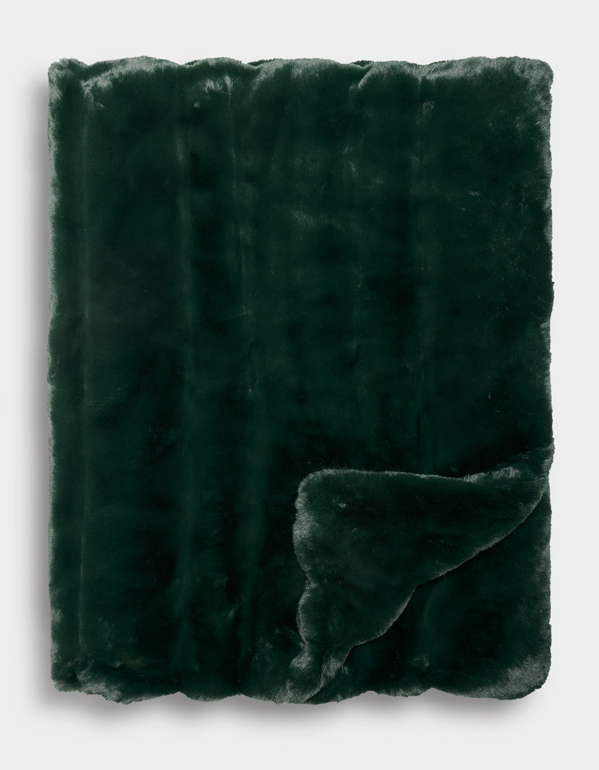 The Cozy Earth Channel Cuddle Blanket is neatly folded, with one corner turned up to reveal its plush texture on both sides. The dark green faux fur looks exceptionally soft and cozy.|Color:Emerald