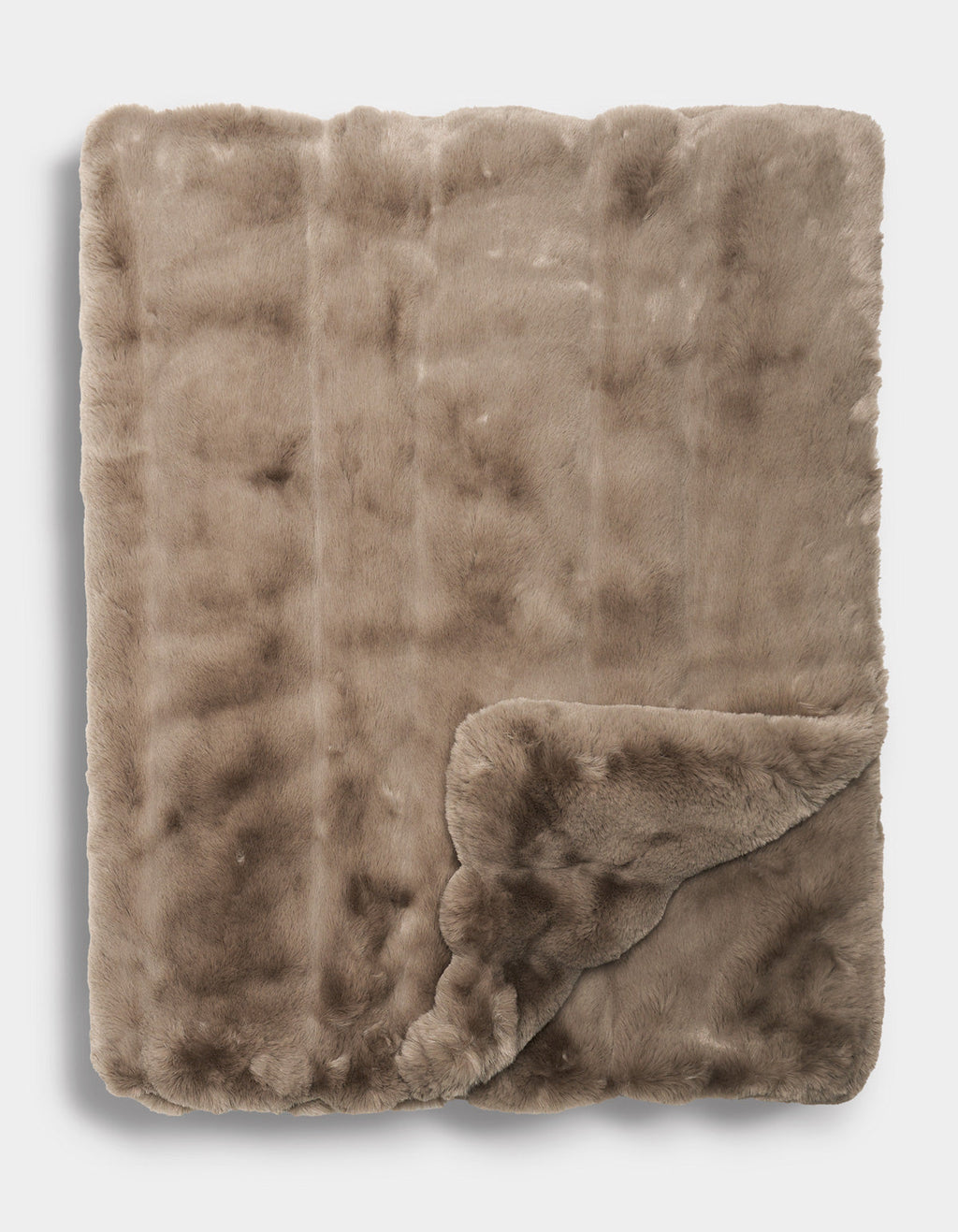 The Cozy Earth Channel Cuddle Blanket in a soft, light brown faux fur is neatly folded with one corner turned up, revealing its plush texture on both sides.|Color:Walnut