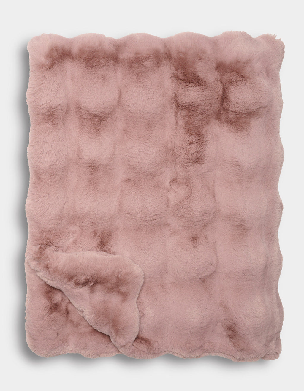 The Double Bubble Cuddle Blanket by Cozy Earth is a folded, blush pink faux fur blanket featuring a textured, slightly quilted pattern and an irresistibly soft, plush appearance.|Color:Viola