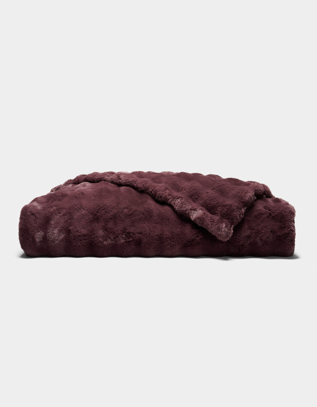 A folded, plush Bubble Cuddle Blanket by Cozy Earth in dark burgundy, featuring a soft, furry texture, displayed against a plain light gray background.|Color:Raisin