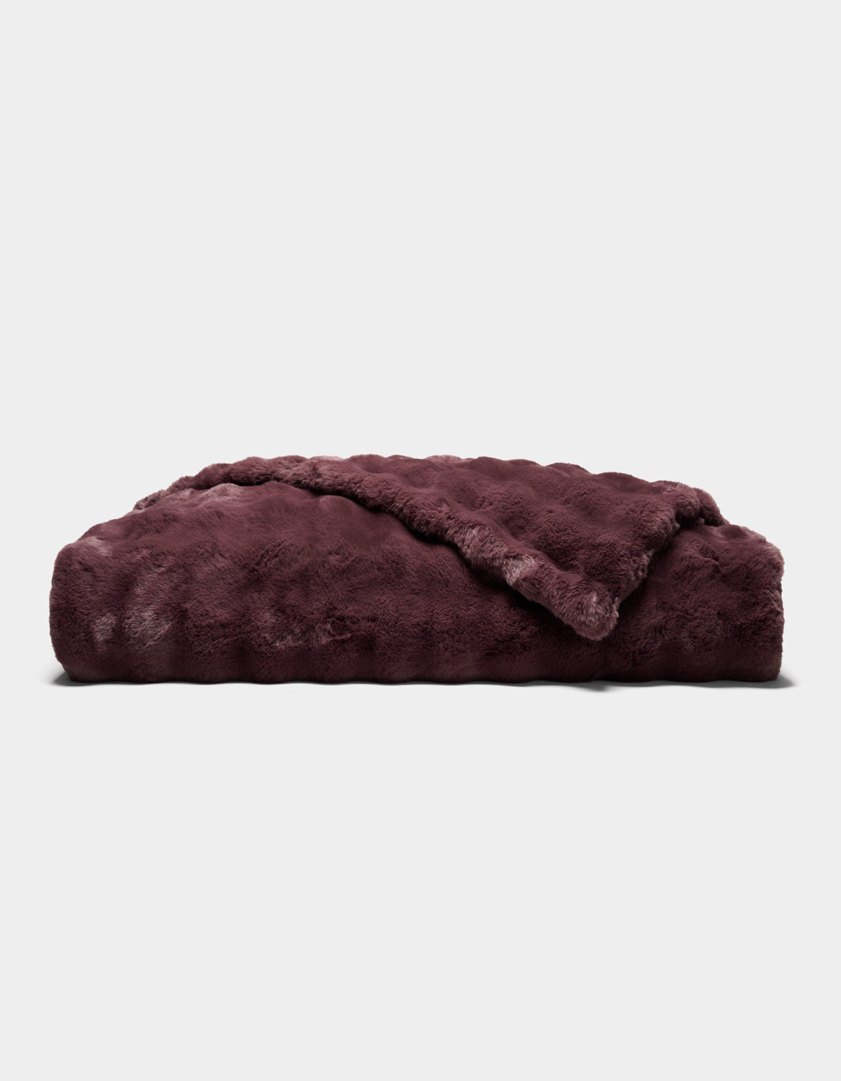 A folded, plush Bubble Cuddle Blanket by Cozy Earth in dark burgundy, featuring a soft, furry texture, displayed against a plain light gray background.|Color:Raisin