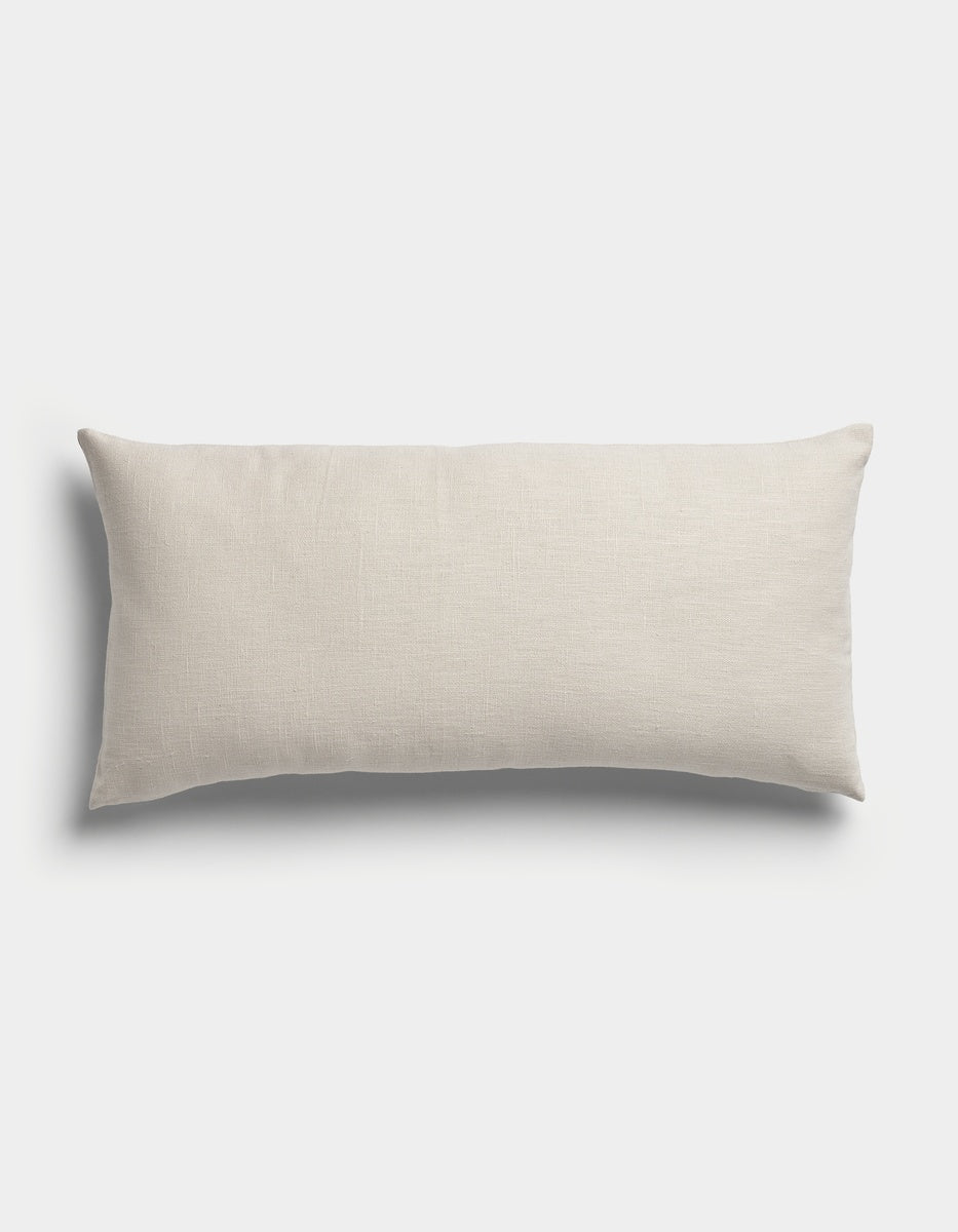 The Sonoma Throw Pillow by Cozy Earth is a rectangular pillow in light beige, featuring a plain, smooth fabric and displayed against a white background.|Color:Canvas|Size:14" x 30"