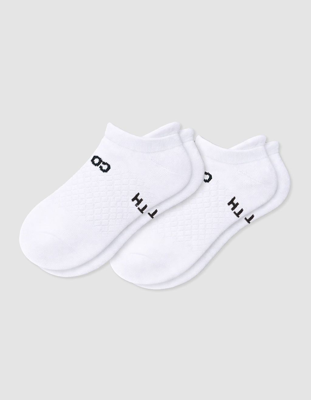 The Women's Essential Ankle Sock by Cozy Earth features a textured white design with subtle black text near the cuff, shown on a light gray background.|Color:White