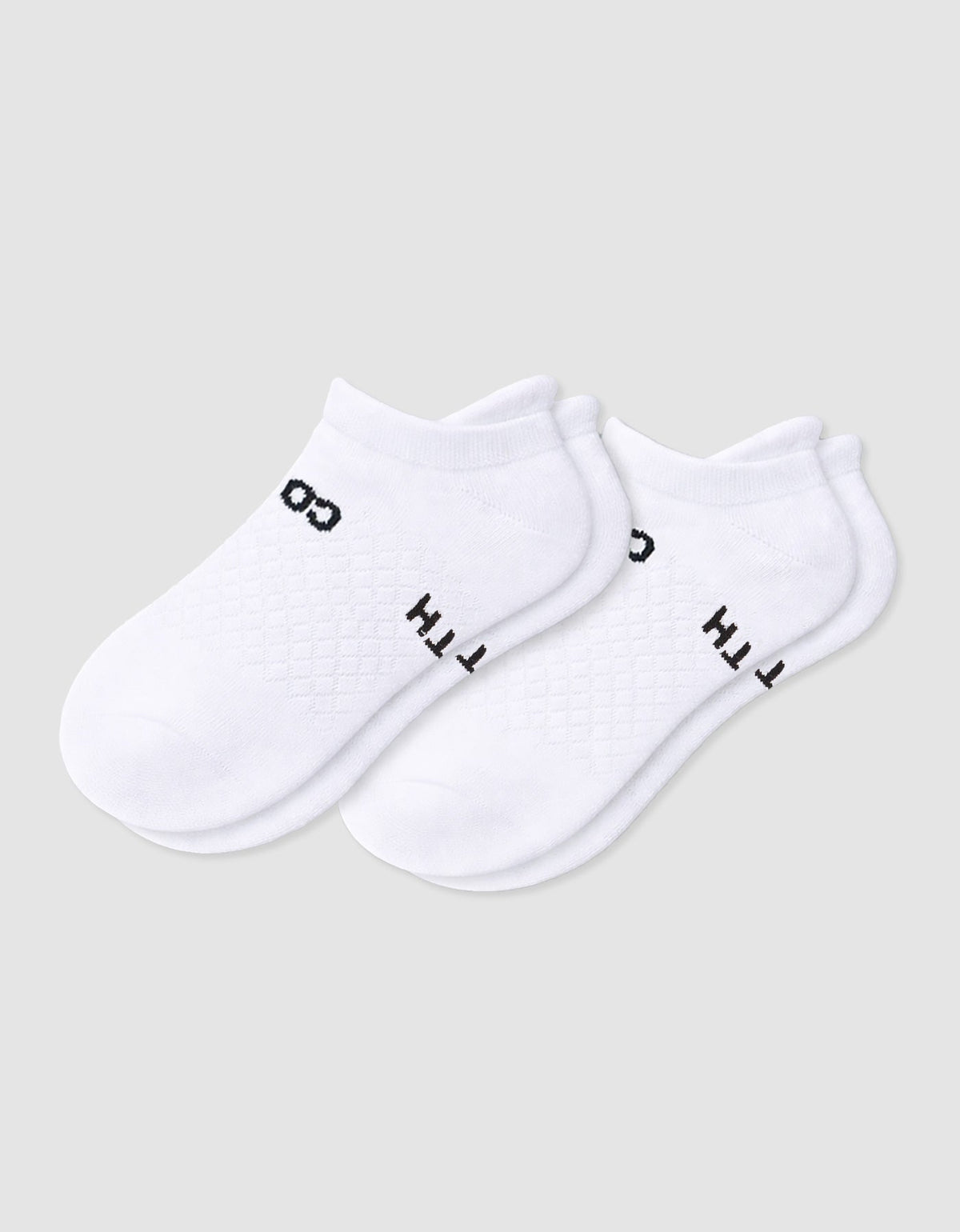 The Women's Essential Ankle Sock by Cozy Earth features a textured white design with subtle black text near the cuff, shown on a light gray background.|Color:White