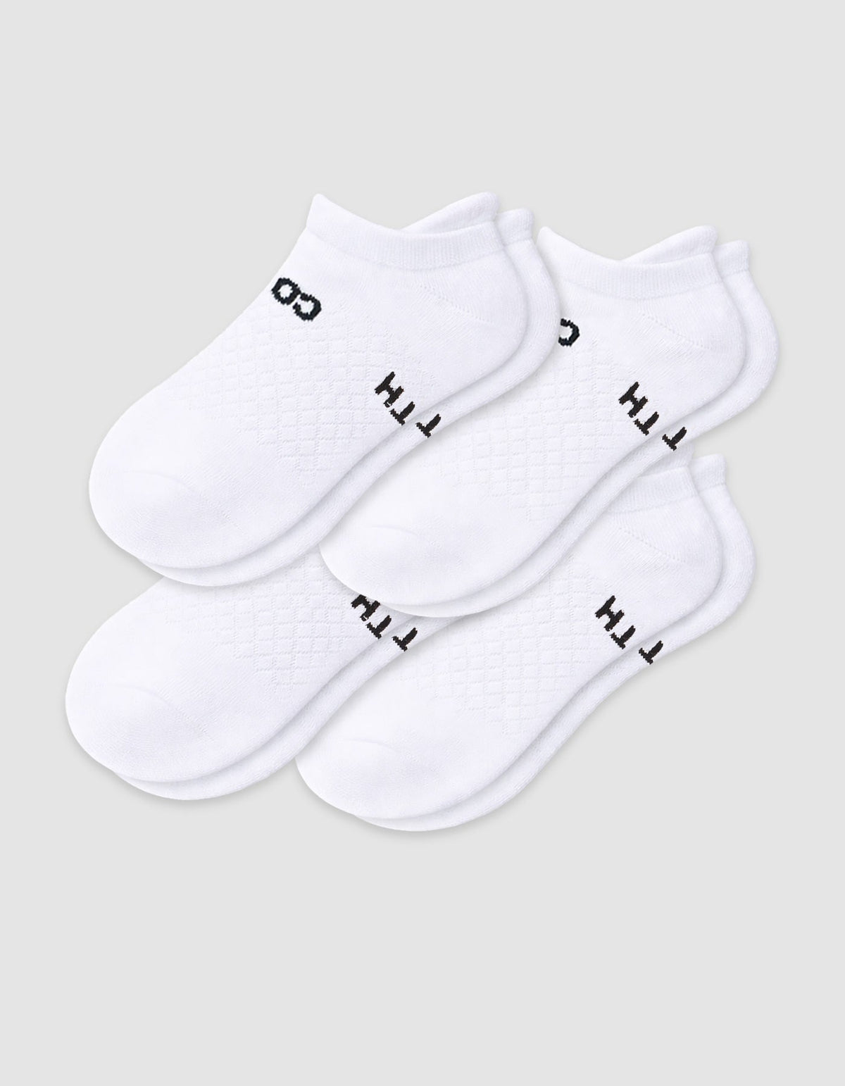 The Cozy Earth Women's Essential Ankle Sock 4-Pack features white ankle socks with black text and designs near the ankles, shown on a light gray background.|Color:White