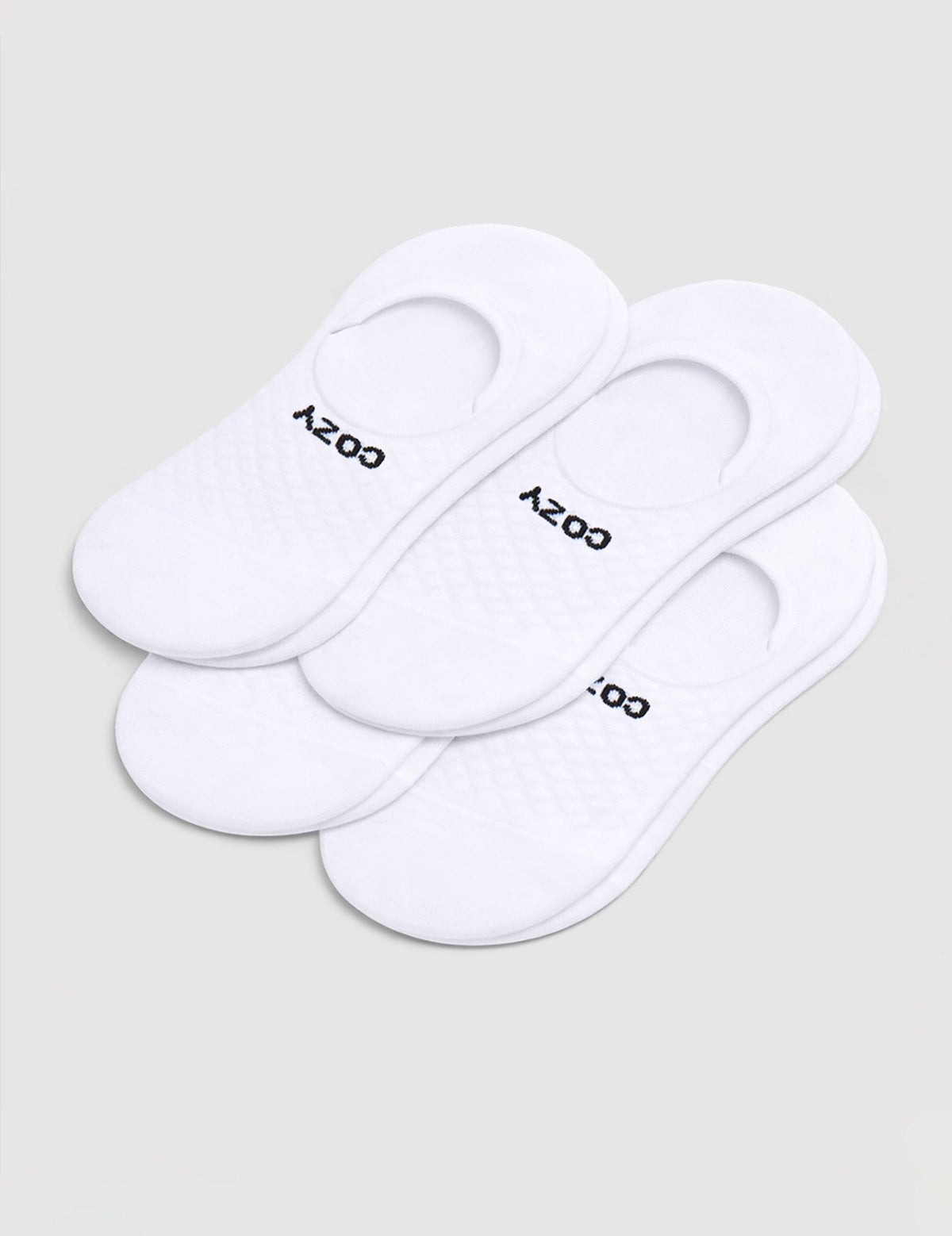 A 4-pack of white Men's Essential No-Show Socks by Cozy Earth, each pair featuring "COZY" in black, displayed on a plain white background.|Color:White