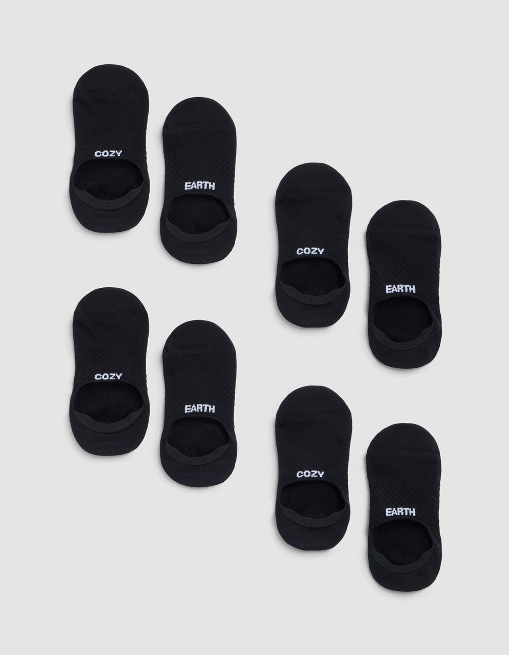 Eight pairs of black Essential No-Show Socks from Cozy Earth on a light gray background—four pairs read "COZY" and four read "EARTH" in white lettering on top. |Color:Black