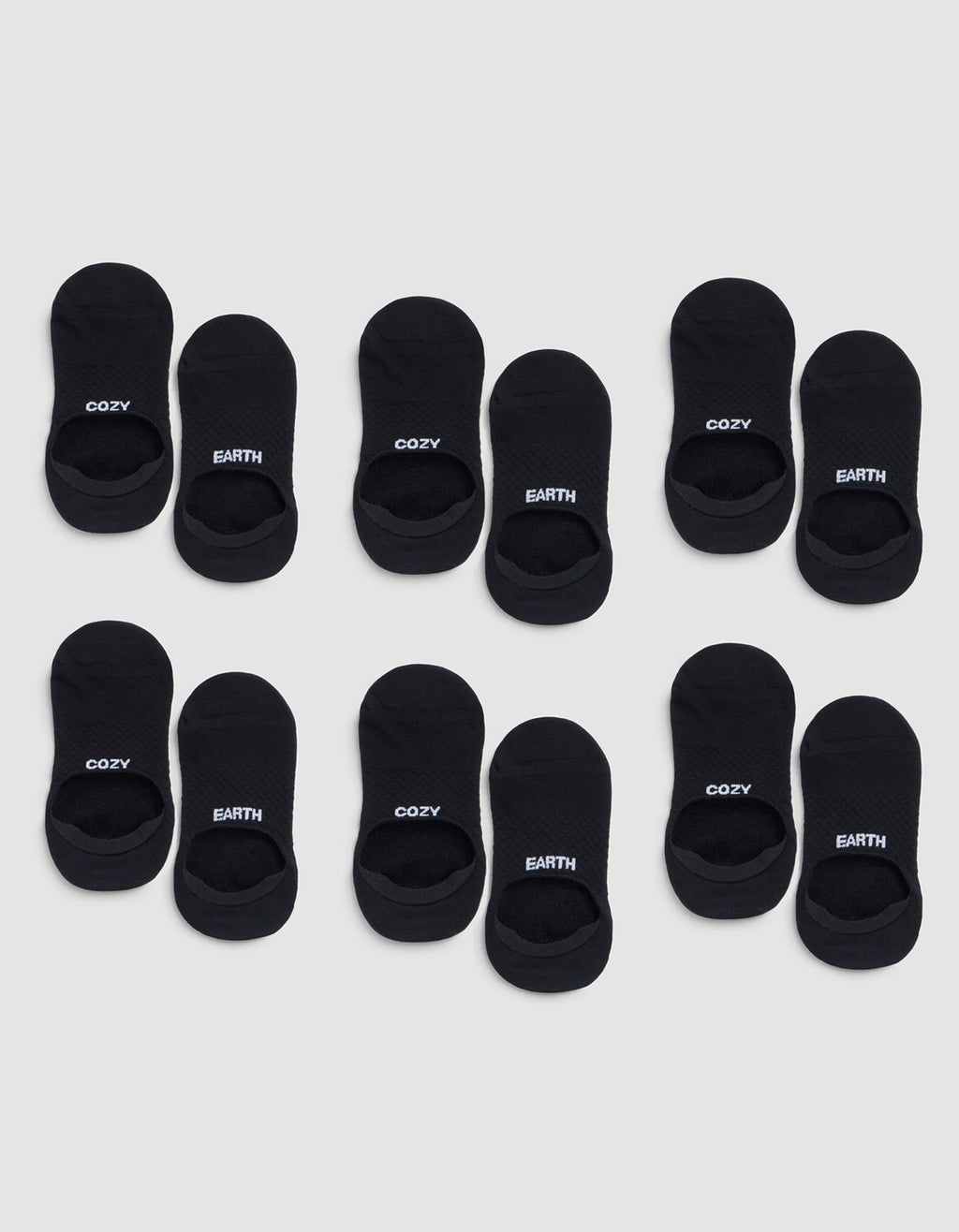 Six pairs of black Essential No-Show Socks by Cozy Earth are arranged in four rows on a light gray background, each labeled "COZY" or "EARTH" near the opening. |Color:Black