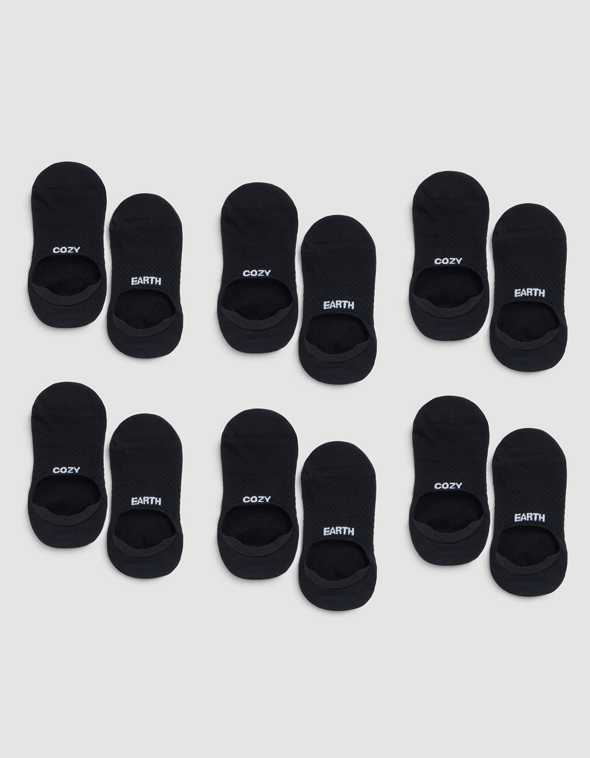Six pairs of black Essential No-Show Socks by Cozy Earth are arranged in four rows on a light gray background, each labeled "COZY" or "EARTH" near the opening. |Color:Black