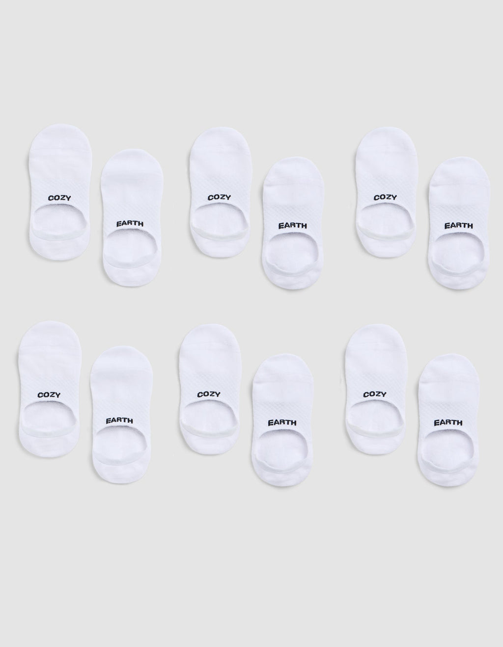A 6-pack of white Essential No-Show Socks by Cozy Earth, each pair featuring "COZY" or "EARTH" in black text on top, displayed on a light gray background. |Color:White