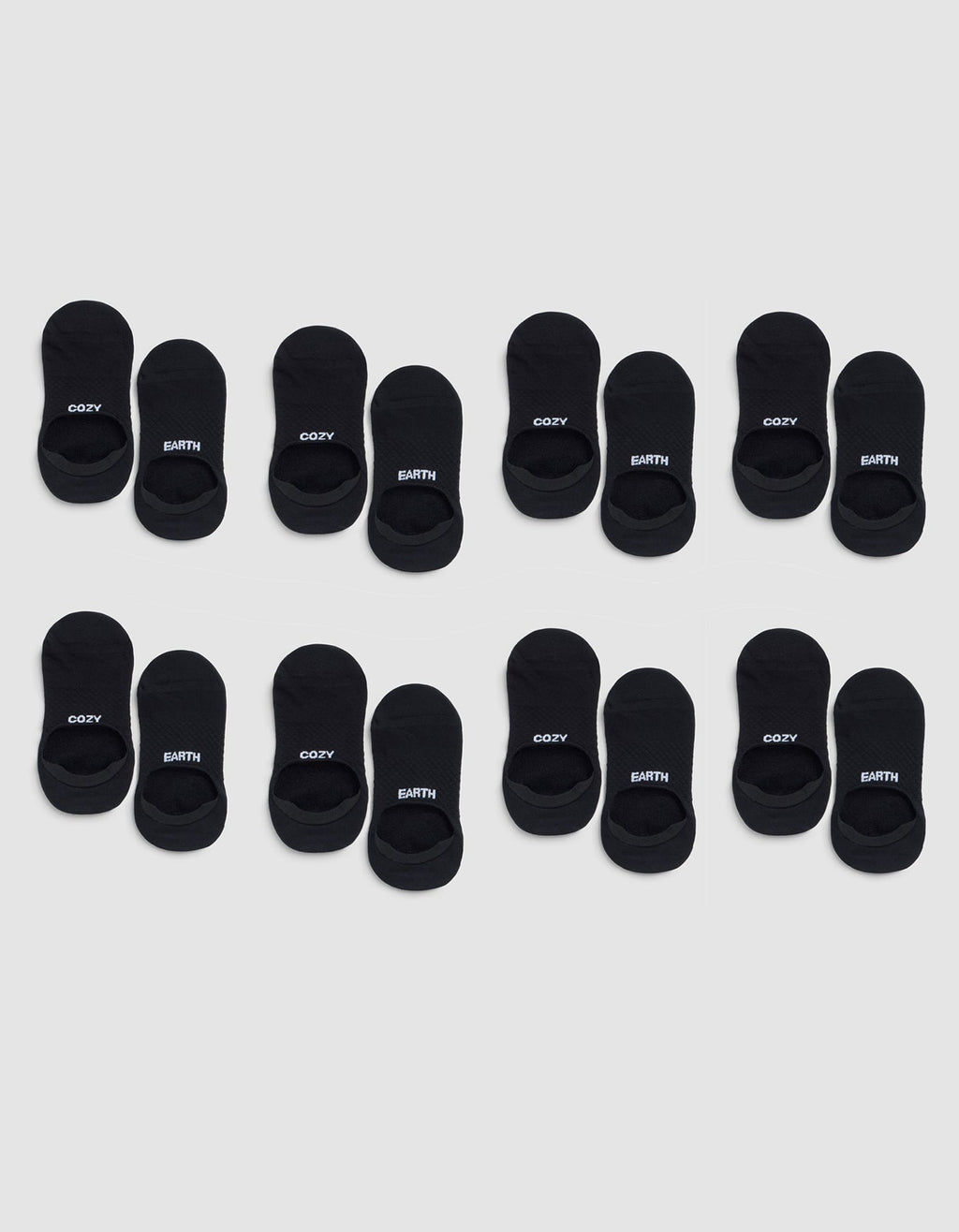 Eight pairs of Cozy Earth Essential No-Show Socks are arranged in three rows on a light gray background, with "COZY" and "EARTH" printed in white letters on the black socks. |Color:Black
