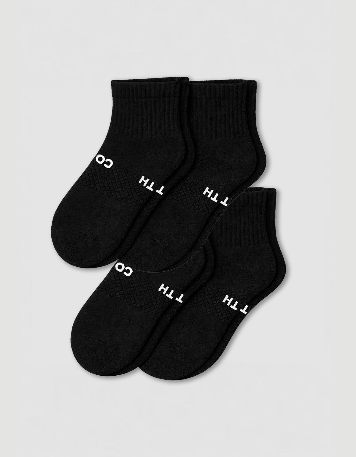 Four pairs of Cozy Earth Women's Essential Quarter Socks in black, featuring ribbed cuffs and white text, are arranged overlapping on a plain light background.
|Color:Black