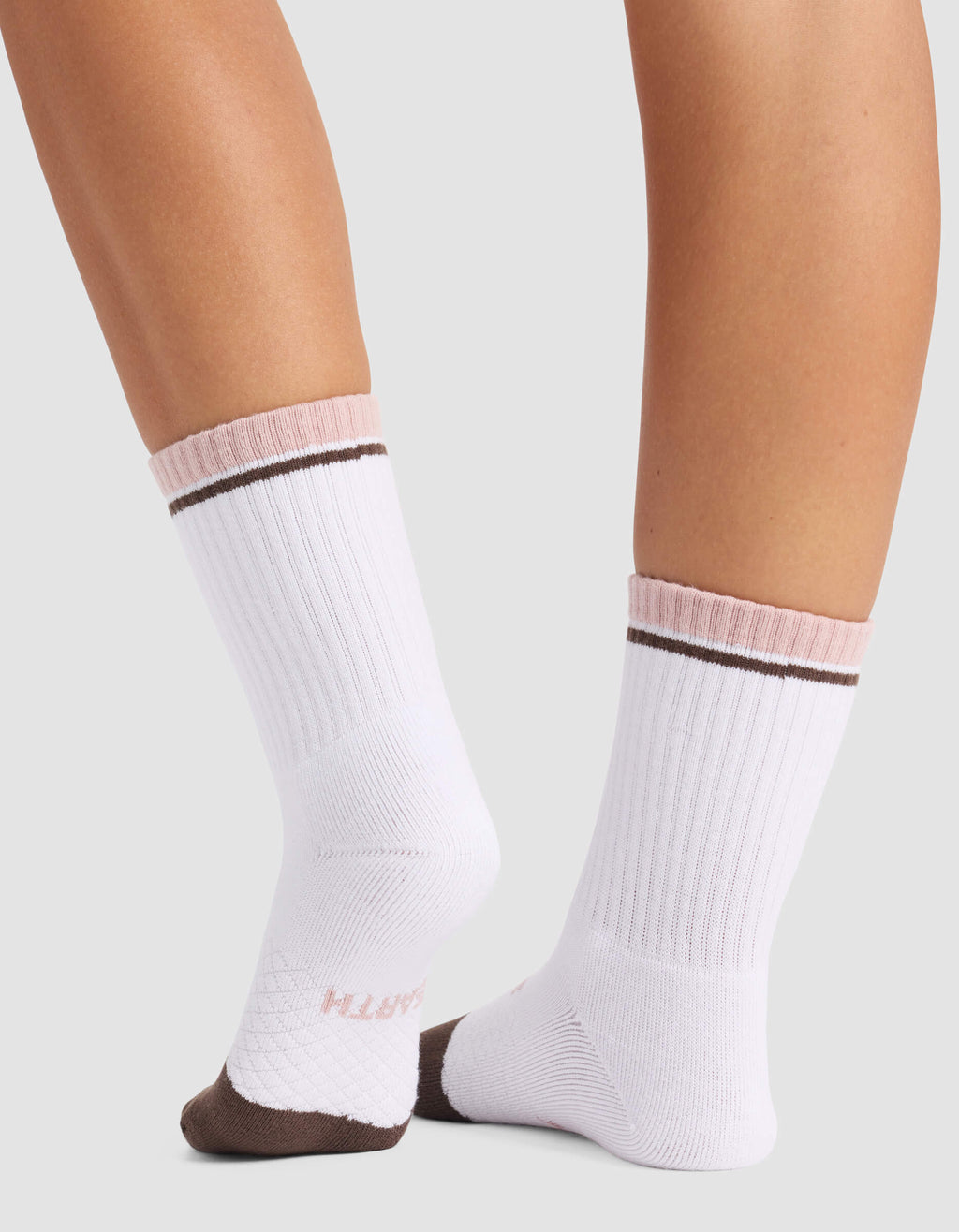 A close-up of lower legs wearing Cozy Earth Women's Essential Calf Socks—white with pink cuffs, brown stripes near the top, brown toes, and "SMITH" in pink on the sole.|Color:Cedar