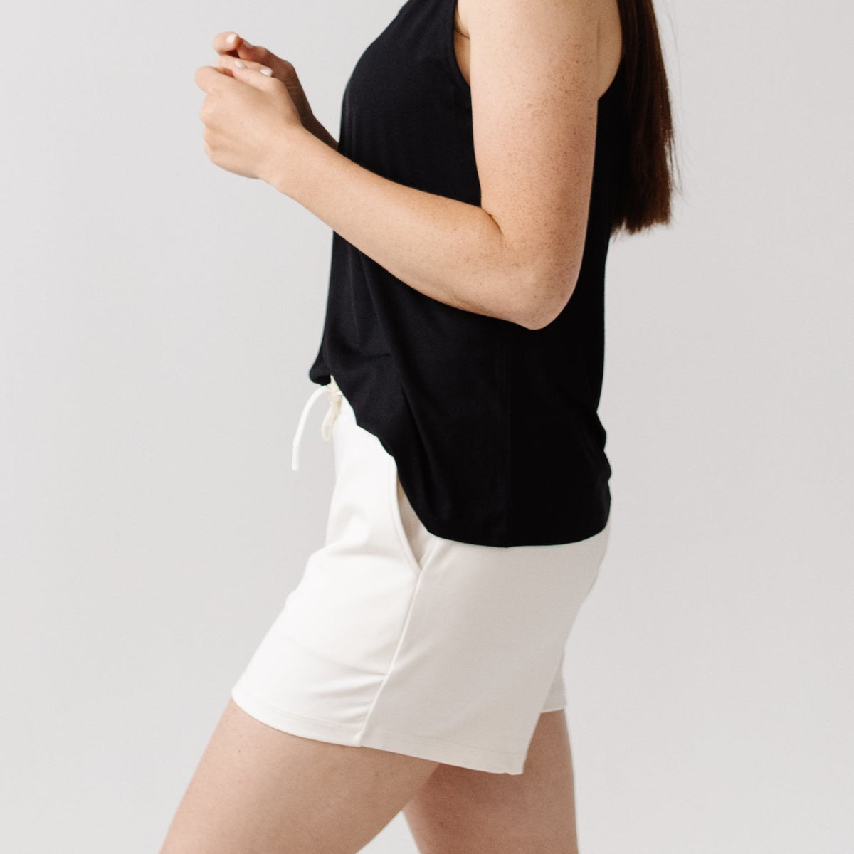 Person wearing Cozy Earth Brushed Bamboo Jogger Shorts in white and a black top |Color:Ivory