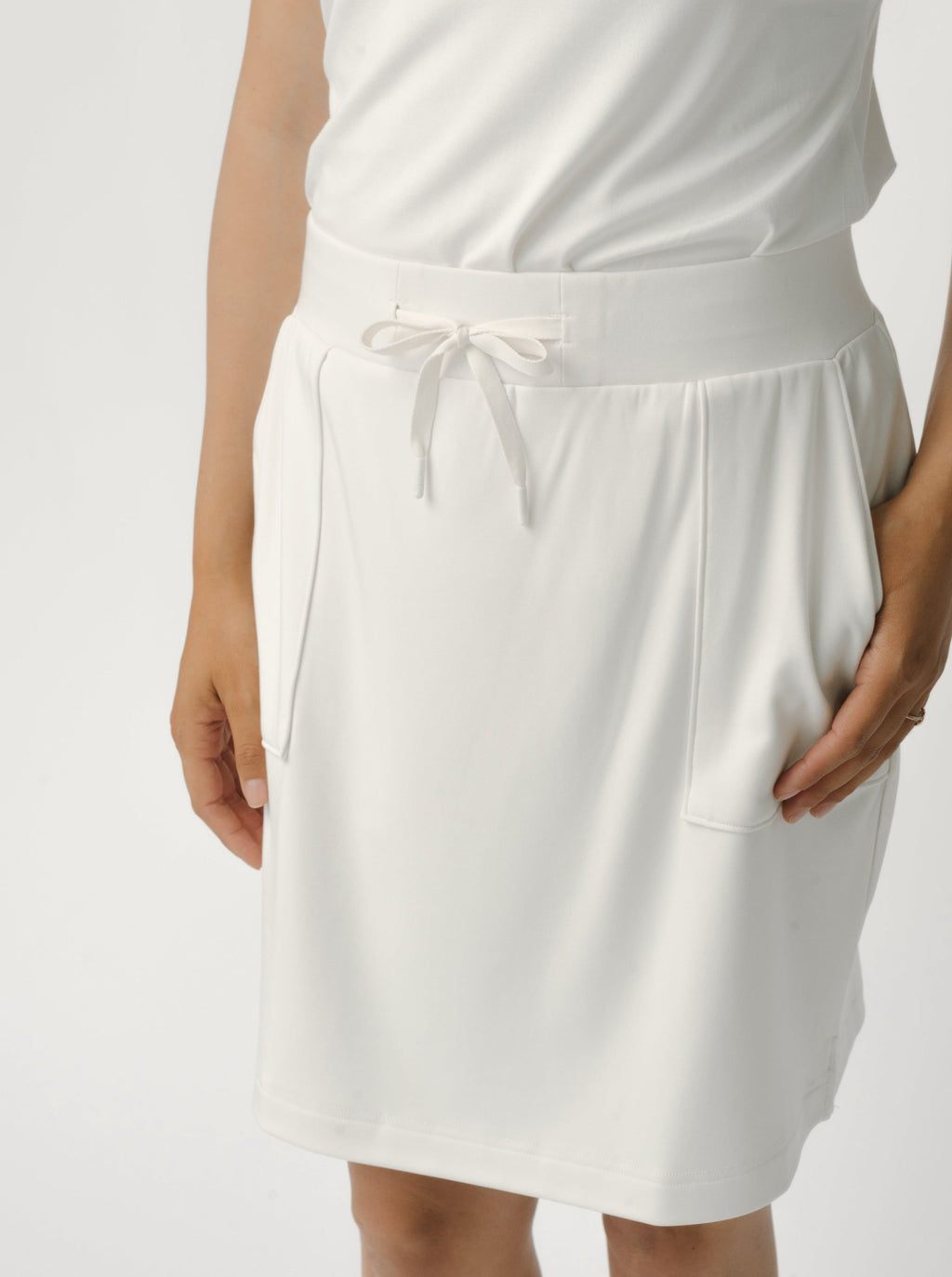 Person wearing a Cozy Earth Brushed Bamboo Patch Pocket Skirt in white on a white background |Color:Ivory