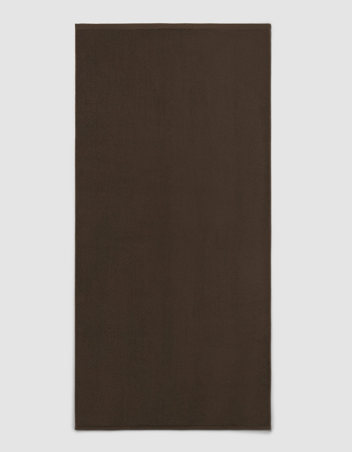 The Cozy Earth Loop Terry Bath Mat is shown on a light gray background. This plain, rectangular bath mat features a dark brown, solid color design without patterns or visible texture.|Color:Espresso