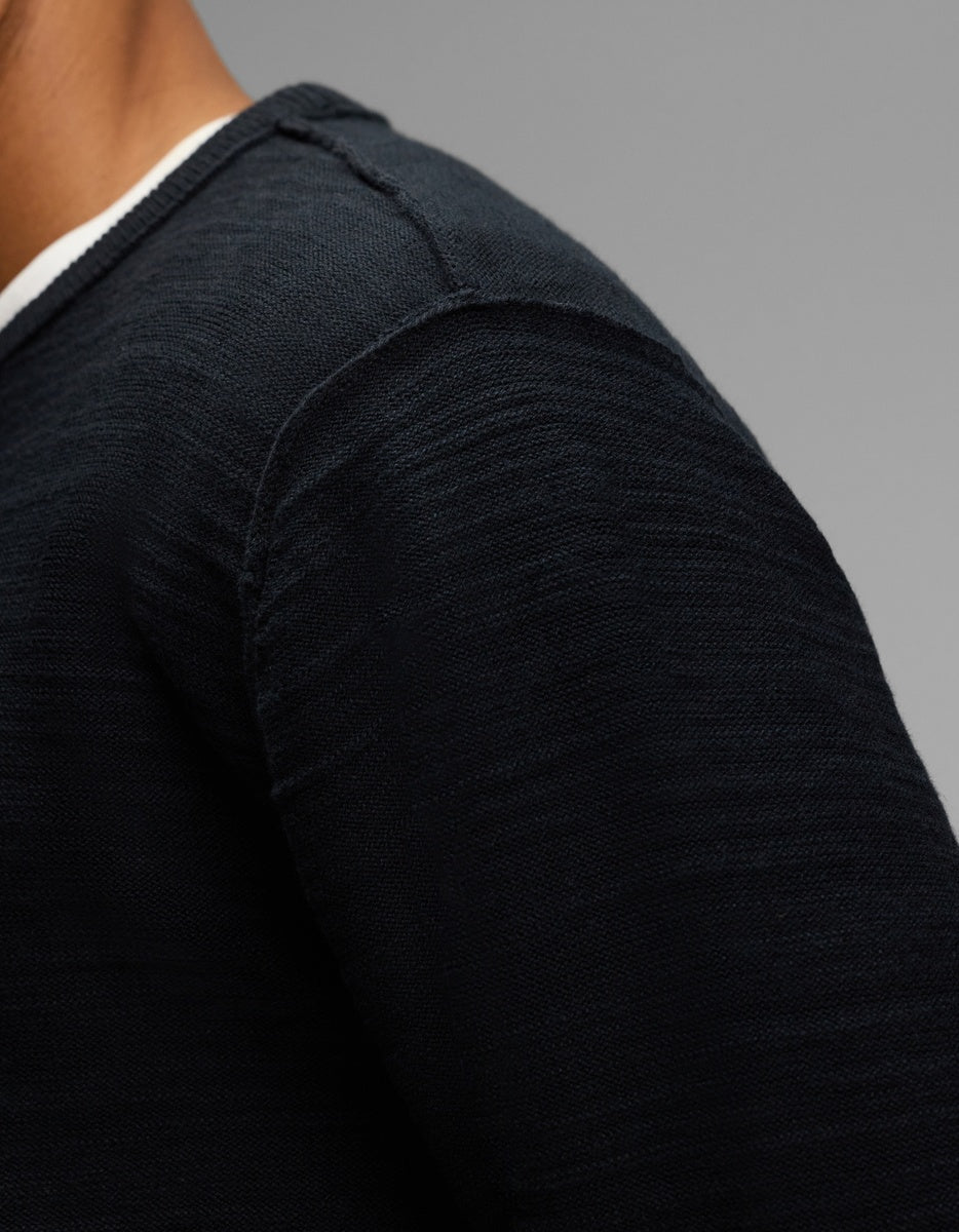 Close-up of a person wearing a dark blue Cozy Earth Men’s Tate Crewneck over a white shirt.|Color:Jet Black