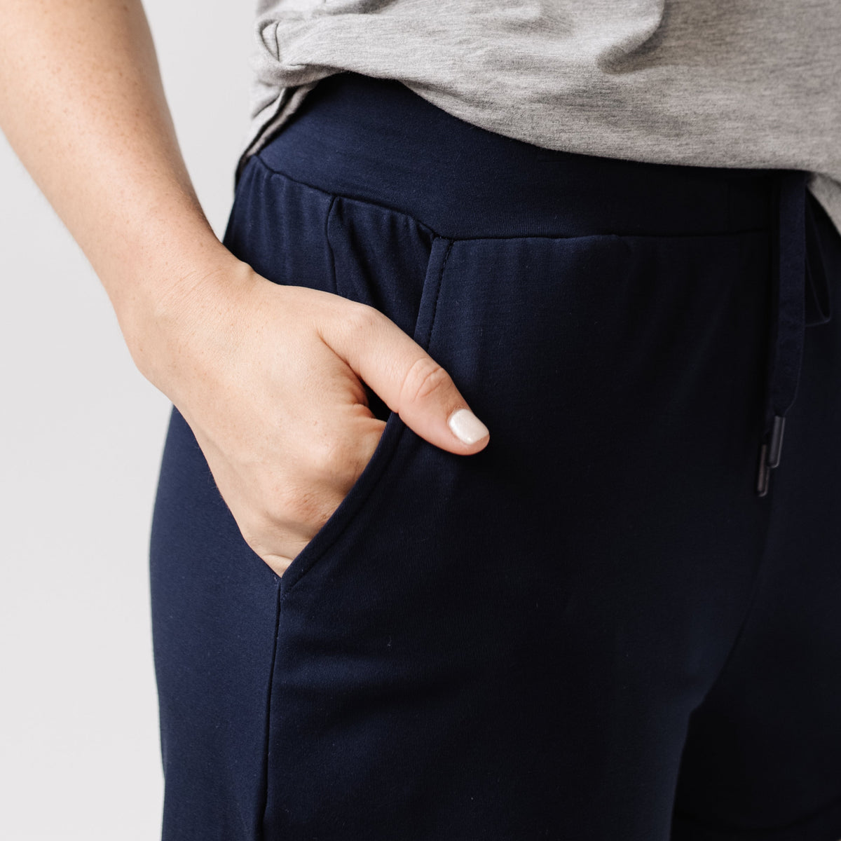 Person wearing Cozy Earth Brushed Bamboo Jogger Shorts in navy and a navy top |Color:Navy