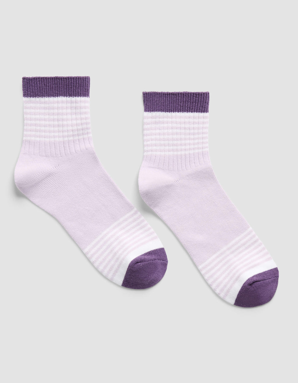 The Women's Sadie Sock by Cozy Earth, in light purple with darker purple toes, heels, and ribbed cuffs, is shown on a plain light gray background.|Color:Lilac/Dusty Orchid/Sea Salt