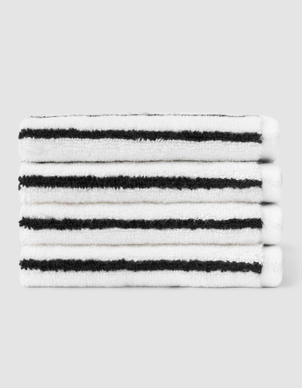 A stack of four neatly folded Cozy Earth Striped Luxe Washcloths in white with evenly spaced black stripes, set against a plain light gray background. |Color:Black Stripe