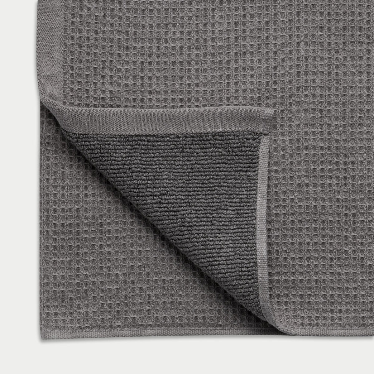 Waffle Bath Towel in the color Charcoal. Photo of Waffle Bath Towel taken close up showing the corner of the towel |Color:Charcoal