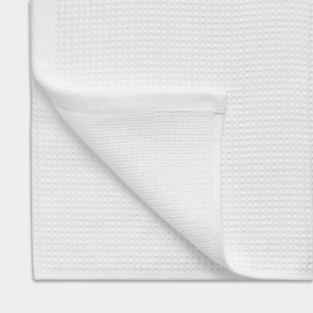 Waffle Bath Towel in the color White. Photo of Waffle Bath Towel taken close up showing the corner of the towel |Color:White