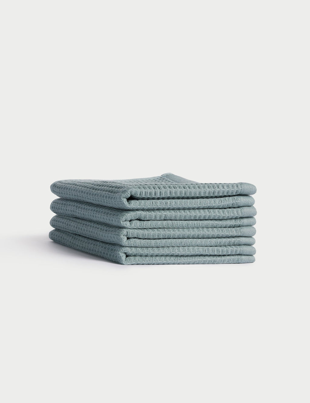 A stack of five neatly folded light blue Cozy Earth Waffle Washcloths is displayed against a plain white background. |Color:Brook