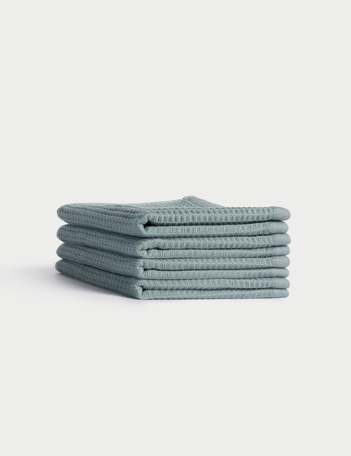 A stack of five neatly folded light blue Cozy Earth Waffle Washcloths is displayed against a plain white background. |Color:Brook