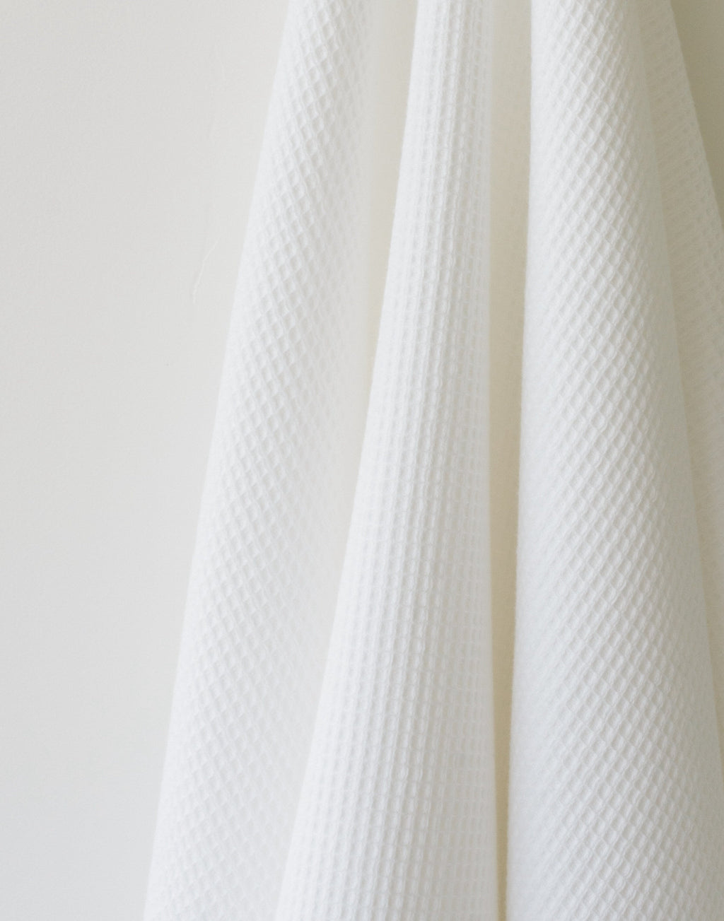 Waffle Bath Towel in the color White. Photo of White Waffle Bath Towel taken as a close up of the White Waffle Bath Towel. The picture shows only the towel |Color: White