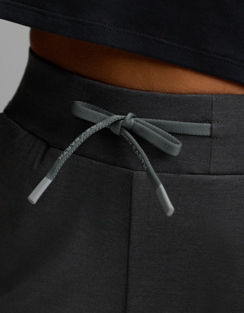 A close-up of the gray drawstring tied in a bow on the waistband of Cozy Earth’s Women’s Brushed Bamboo Jogger in dark gray, worn by a person in a black shirt.|Color:Charcoal
