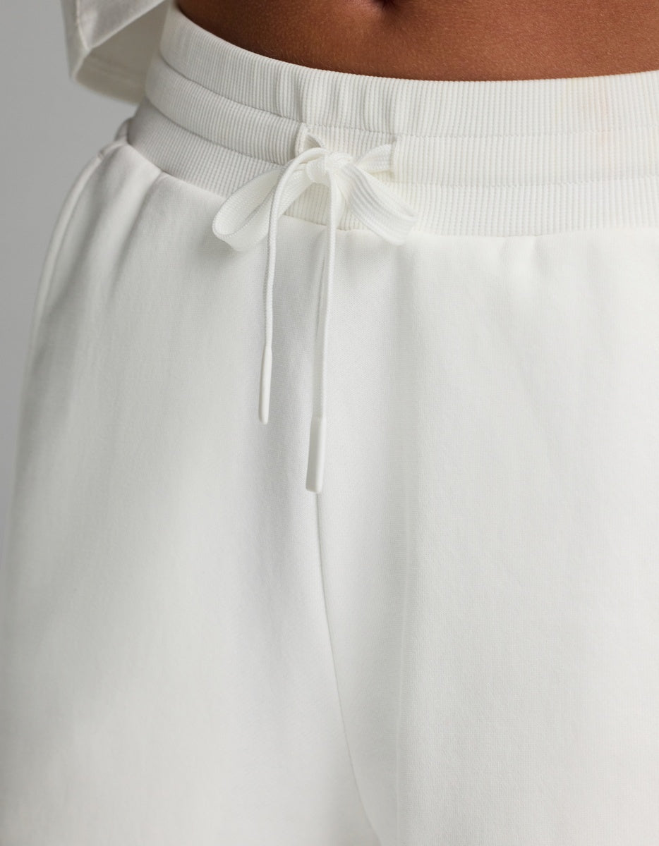 Close-up of a person wearing the Cozy Earth Women’s Chelsea Pant in white, paired with a matching white top, highlighting the waistband and tied drawstring.|Color:Bone