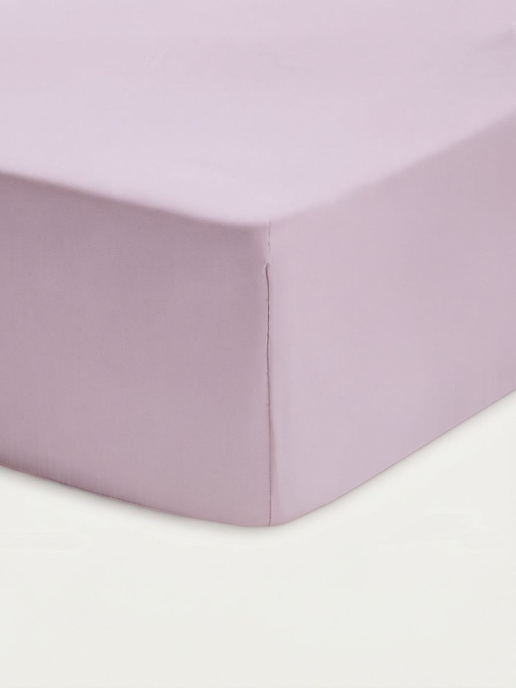 Close-up of the Cozy Earth Bamboo Fitted Sheet in a light lavender hue, snugly covering the corner of a mattress with a smooth, neatly tailored finish against a white background.|Color:Lavender